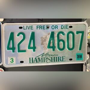 New Hampshire License Plate with Green Text